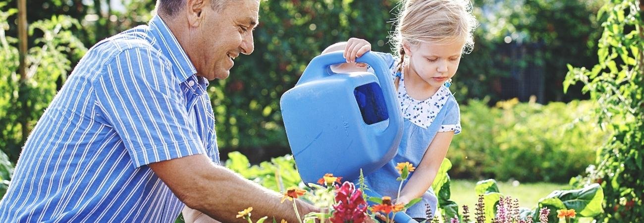 A kid gardening with her dad